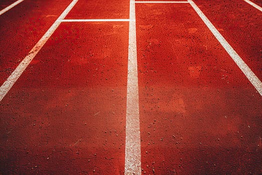 Empty red running track at the stadium. Concept of running, sport, competition.