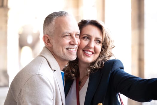 Smiling caucasian woman and man taking a selfie outside. Concepts of vitality, people's lifestyle, diversity, urban life