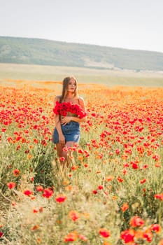 Woman poppies field. portrait of a happy woman with long hair in a poppy field and enjoying the beauty of nature in a warm summer day