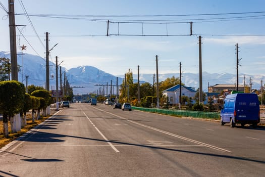 street of small Central Asia town at sunny autumn afternoon in Balykchy, Kyrgyzstan in October 21, 2022