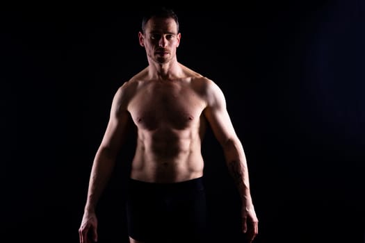 Portrait of man, bodybuilder and bicep flex in a studio, background and exercise for muscular power.