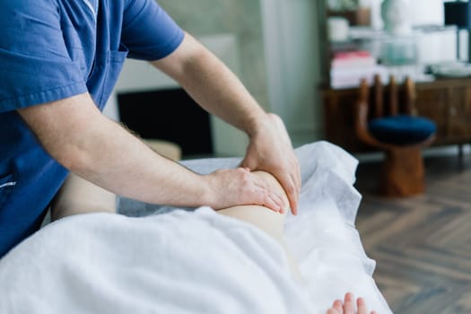 Anti-cellulite foot massage for fat woman. Concept of personal care, weight loss, diet. Close-up.