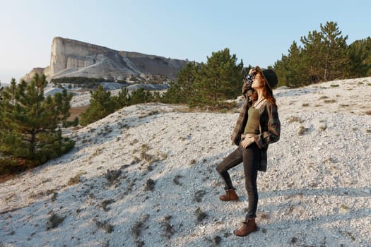 female photographer capturing breathtaking mountain view from the summit