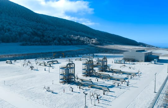 Winter landscape with natural gas filtration units at a gas metering station.