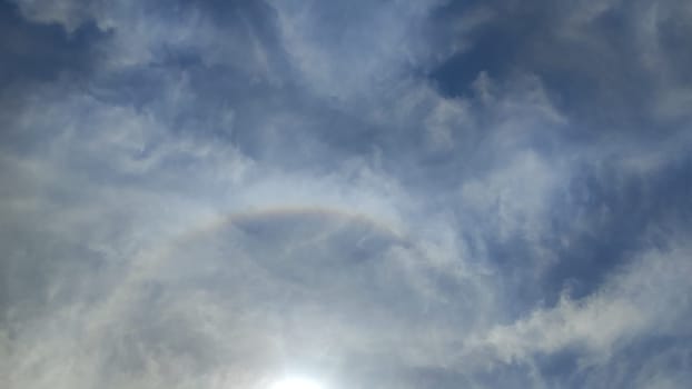 sun sky clouds rays of light background halo circle nature. High quality photo
