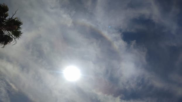 sun sky clouds rays of light background halo circle nature. High quality photo