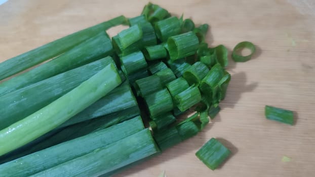 green fresh onions on the kitchen board, food snack. High quality photo