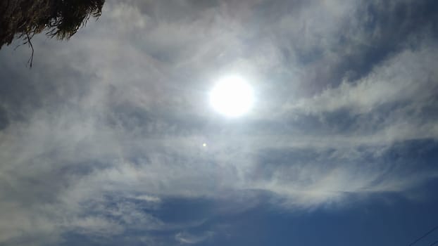 sun sky clouds rays of light background halo circle nature. High quality photo