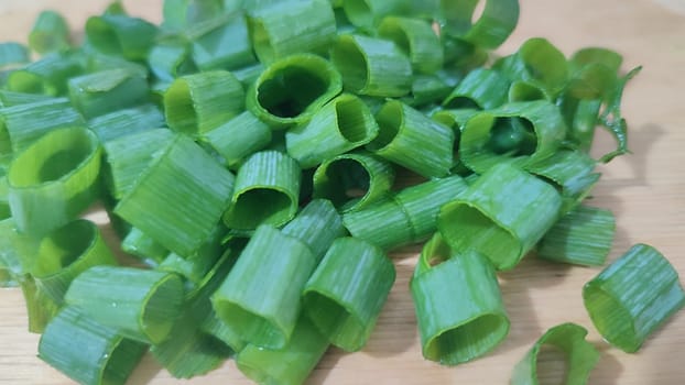 green fresh onions cut on the kitchen board, food snack. High quality photo