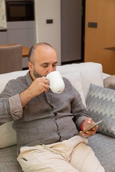 Cozy relaxation with phone and drink