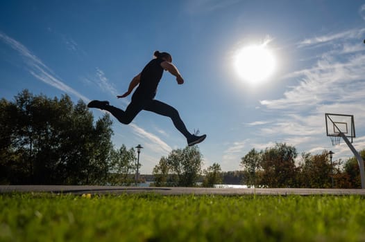 Caucasian man jumping with high hip raise outdoors