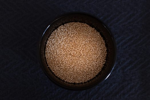 Top view photo, of quinoa seeds, close up, black background.Isolated Healthy eating