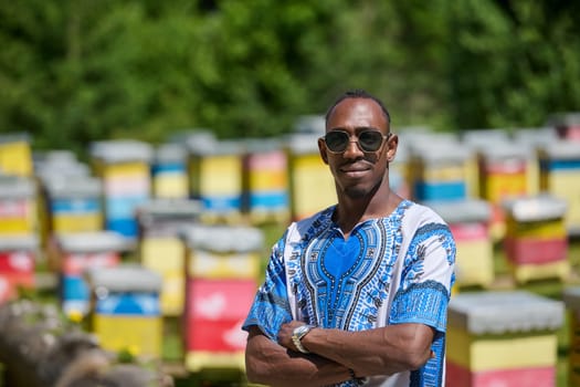 African American teenager clad in traditional Sudanese attire explores small beekeeping businesses amidst the beauty of nature