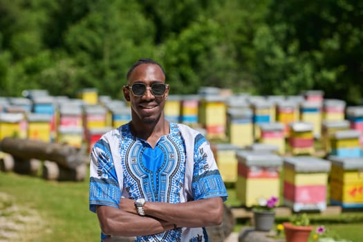 African American teenager clad in traditional Sudanese attire explores small beekeeping businesses amidst the beauty of nature