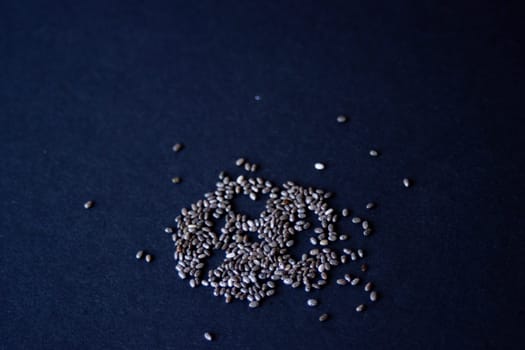 Chia grains, source of vitamins and omega-3.Close-up photo.with dark background. Copy space.