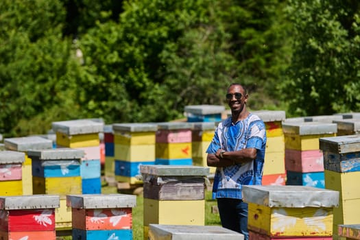 African American teenager clad in traditional Sudanese attire explores small beekeeping businesses amidst the beauty of nature