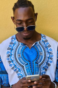 African American teenager adorned in traditional Sudanese clothing, seamlessly navigating the digital world with a smartphone in hand.