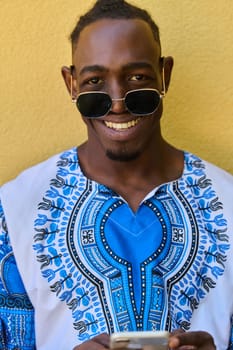 African American teenager adorned in traditional Sudanese clothing, seamlessly navigating the digital world with a smartphone in hand.