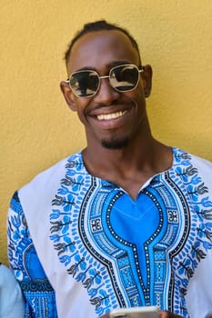 African American teenager adorned in traditional Sudanese clothing, seamlessly navigating the digital world with a smartphone in hand.