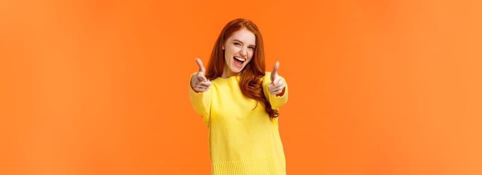 Excited, carefree cool modern hipster girl with red hair showing thumbs-up in approval, rooting for friend saying yeah, yes gesture, feeling upbeat and delighted, recommend product, fully-satisfied.