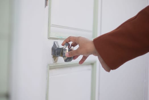 Man's Hand Opening door close up .