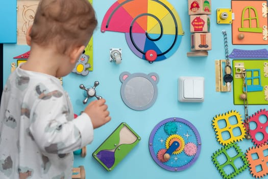 View of a busy board and a child playing with it.