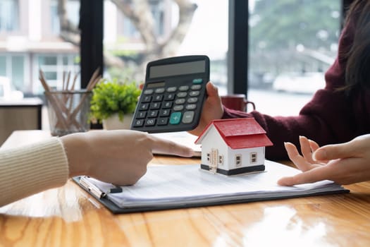 Real estate agent showing home loan interest to client. Concept of financial consultation and mortgage.