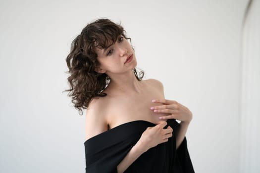 young beautiful woman posing in black lingerie in the studio