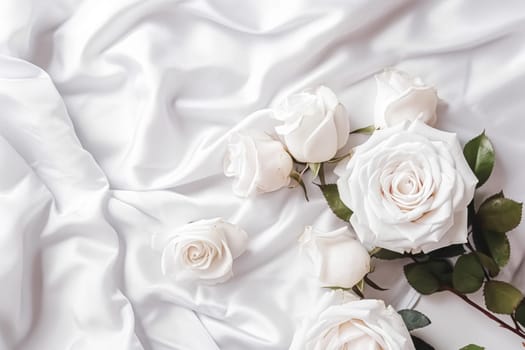 Floral composition. White flowers on white fabric. Flat lay, top view, copy space.