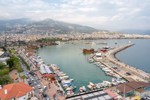 Antalya, Turkey - April 12, 2024: View of Alanya marina and walking path, one of the touristic districts of Antalya, from the Red Tower