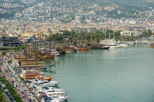 Antalya, Turkey - April 12, 2024: View of Alanya marina and walking path, one of the touristic districts of Antalya, from the Red Tower