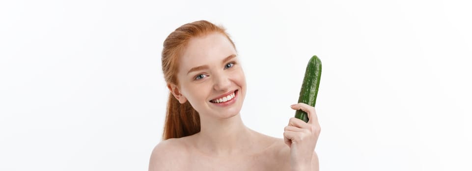 Cheerful happy beautiful girl with cucumber on her hand - isolated on white.