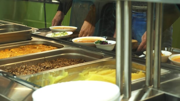 close-up, showcase with dishes in modern Self service canteen, cafeteria, mess hall, factory employees having lunch in the canteen, they are Served Meal In factory Canteen. High quality photo