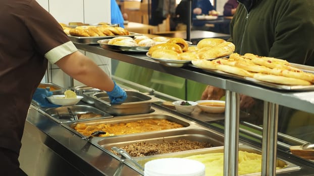 close-up, showcase with dishes in modern Self service canteen, cafeteria, mess hall, factory employees having lunch in the canteen, they are Served Meal In factory Canteen. High quality photo