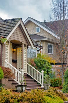 Doorsteps and porch of residential house on autumn day in British Columbia.