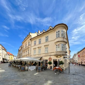 Street restaurant gardens in the Old Town and traditional rolls, street leading to Michael's gate tower