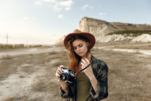 vintage camera enthusiast captures stunning mountain landscape in open field