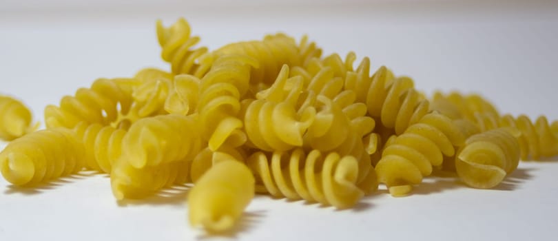 Isolated corkscrew noodles. Healthy food. Ingredient for Italian food.