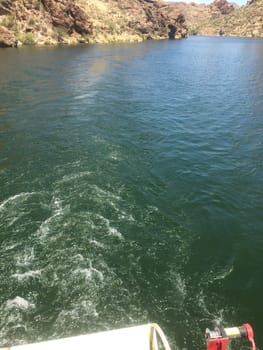 Ripples from a Boat Motor in the Water at Canyon Lake, Boating in Arizona. High quality photo