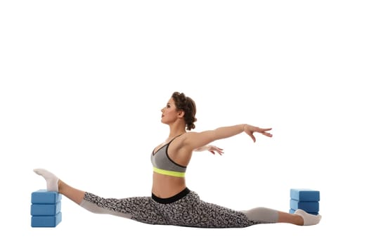 Image of female gymnast exercising using gymnastic bricks