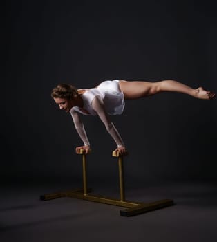 Beautiful female acrobat training on circus stands