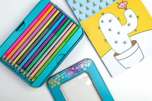 Colored pencils for drawing various colors and coloring book for children. Children's creativity concept.