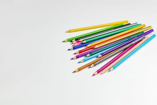 Colored pencils for drawing various colors on a white background. Copenhagen, Denmark - January 24, 2024