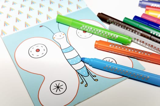 Colored markers for drawing various colors andcoloring book for children. High quality photo