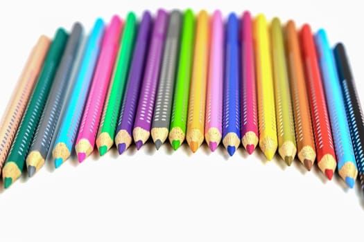 Colored pencils for drawing various colors on a white background. High quality photo