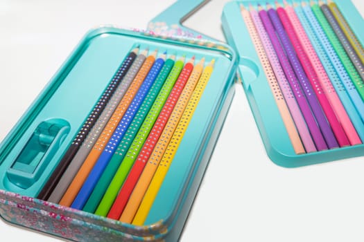 Colored pencils for drawing various colors on a white background. High quality photo