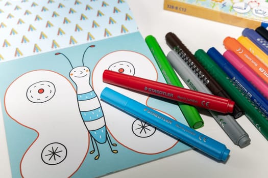Colored markers for drawing various colors andcoloring book for children. Denmark - 9 February 2024