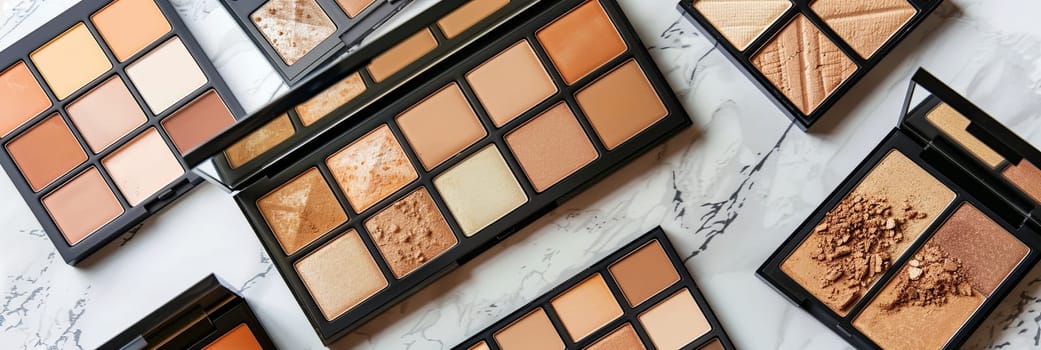 A close-up image of multiple contouring and highlighter palettes on a light background.