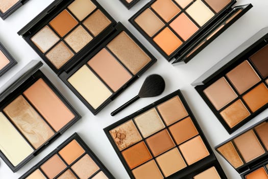 A close-up shot of various contouring and highlighting palettes arranged on a white background. The palettes feature a variety of shades and textures, perfect for creating a sculpted and radiant look.