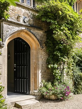 Entrance to a historic manor, framed by antique architectural elements and flanked by potted topiaries, features an aged door, the surrounding ivy and stonework add to the timeless elegance of the property